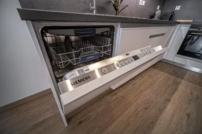 a dishwasher with its door open in a kitchen at Grunt Apartments in Mladá Boleslav