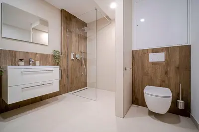 a bathroom with a toilet and a glass shower at Grunt Apartments in Mladá Boleslav