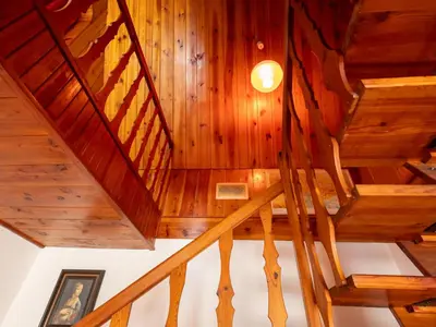 a wooden staircase in a home with wood paneling at Holiday Home Jestřebice 8 by Interhome in Dobřeň