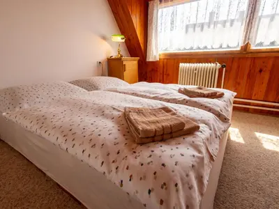 a bedroom with a bed with two towels on it at Holiday Home Jestřebice 8 by Interhome in Dobřeň