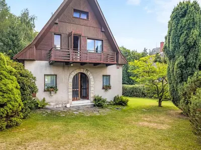 an old house with a balcony and a yard at Holiday Home Jestřebice 8 by Interhome in Dobřeň