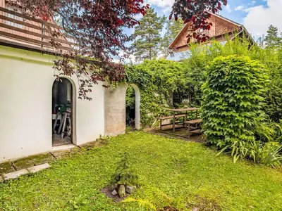 a yard with a white building with a door and grass at Holiday Home Jestřebice 8 by Interhome in Dobřeň