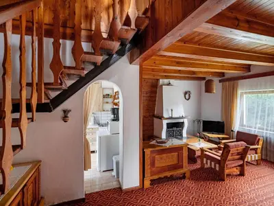 a kitchen and dining room with a table and a refrigerator at Holiday Home Jestřebice 8 by Interhome in Dobřeň