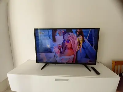 a flat screen tv sitting on top of a white cabinet at apartment golden Prague in Prague