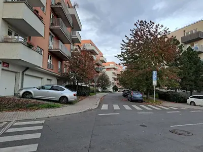 an empty street with cars parked on the side of a building at apartment golden Prague in Prague