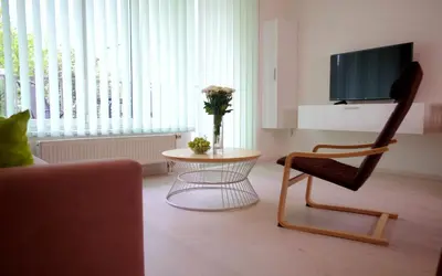 a living room with a chair and a table at apartment golden Prague in Prague