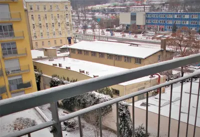 a view of a city in the snow from a balcony at soukromý pokoj in Prague