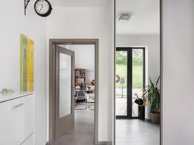 a pivot door in a kitchen leading to a dining room at Apartment Lány by Interhome in Lány