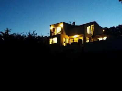 a large house with its lights on at night at Apartment Lány by Interhome in Lány