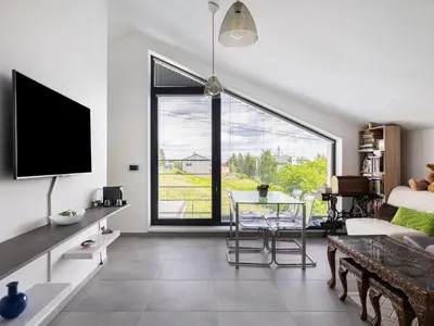 a living room with a table and a large window at Apartment Lány by Interhome in Lány