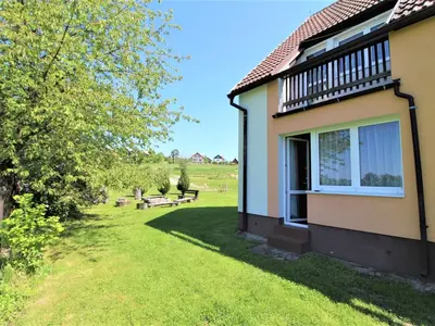 a house with a grass yard next to a building at Apartment Rabyně-1 by Interhome in Rabyně