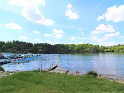 a boat is docked at a dock on a lake at Apartment Rabyně-1 by Interhome in Rabyně