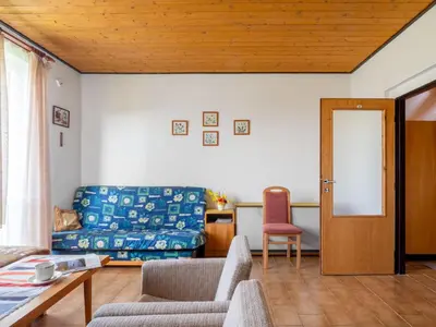 a living room with a couch and a table at Apartment Rabyně-1 by Interhome in Rabyně