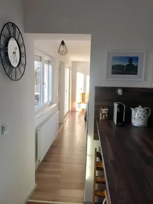 a hallway with a large clock on a wall at Apartmán - D - Vyhlídka nad řekou in Zdiby