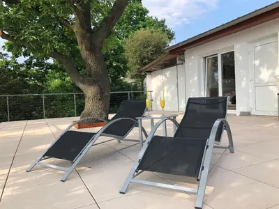 a table and chairs on a patio with a tree at Apartmán - D - Vyhlídka nad řekou in Zdiby