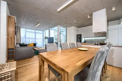 a kitchen and dining room with a wooden table and chairs at Residence Soukenicka in Prague