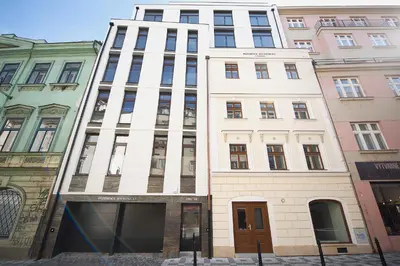 a tall white building with a lot of windows at Residence Soukenicka in Prague
