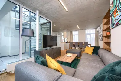 a living room with a couch and a tv at Residence Soukenicka in Prague