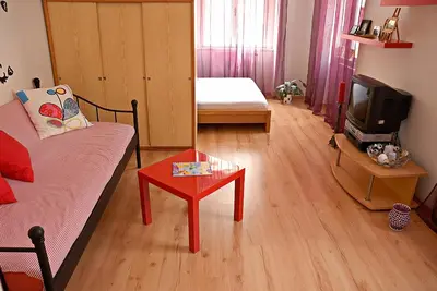 a living room with a couch and a table and a tv at Just BE that´s enough!! in Prague
