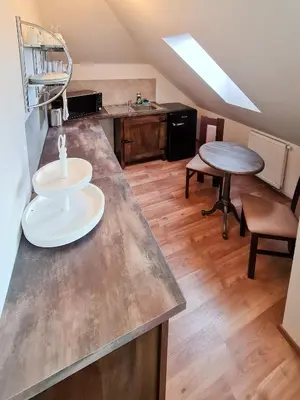 a kitchen with a counter top and a table at Apartmán Praha Břevnov in Prague