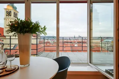 a room with a table and a window with a clock tower at Residence Rybna 9- Old Town in Prague