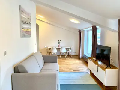 a living room with a couch and a tv and a table at Residence Rybna 9- Old Town in Prague