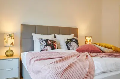 a bed with colorful pillows on top of it at Residence Rybna 9- Old Town in Prague