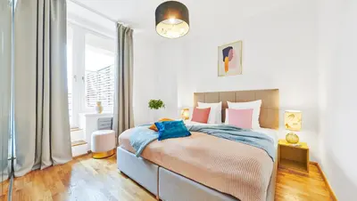 a bedroom with a bed and a large window at Residence Rybna 9- Old Town in Prague