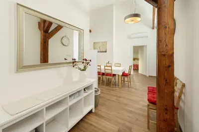 a living room with a mirror and a table at Unesco Prague Apartments in Prague