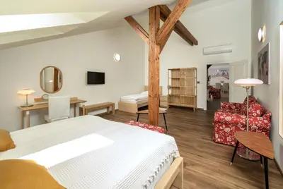 a bedroom with a bed and a living room at Unesco Prague Apartments in Prague