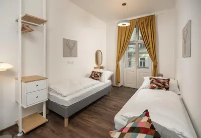 a bedroom with two beds and a window at Unesco Prague Apartments in Prague