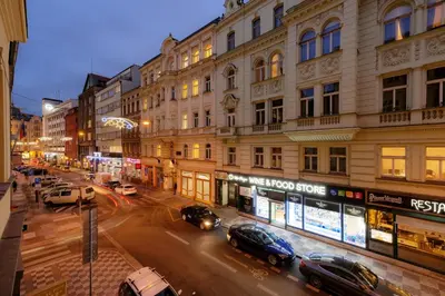 a city street with cars parked in front of buildings at Unesco Prague Apartments in Prague