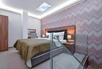 a bedroom with a bed and a wooden headboard at Hotel Prague Star in Prague