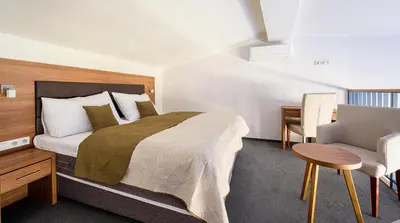 a bedroom with a bed and a desk and a chair at Hotel Prague Star in Prague