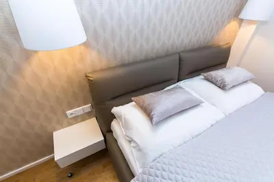 a bed with two pillows on it in a room at TOP location OLD town brand new 2BD apartment in Prague