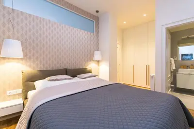 a bedroom with a bed with a blue comforter at TOP location OLD town brand new 2BD apartment in Prague