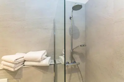 a shower with towels on a rack in a bathroom at TOP location OLD town brand new 2BD apartment in Prague