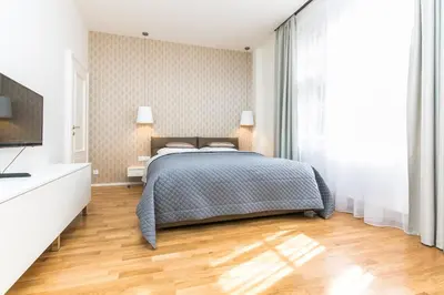a bedroom with a bed and a television in it at TOP location OLD town brand new 2BD apartment in Prague