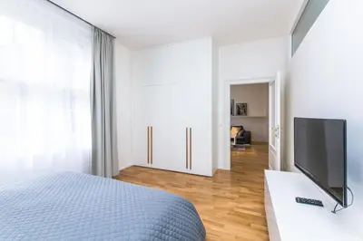 a bedroom with a bed and a flat screen tv at TOP location OLD town brand new 2BD apartment in Prague