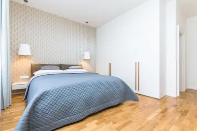 a bedroom with a bed with a blue blanket at UNIQUE Old Town apartments at Palace Dlouha in Prague