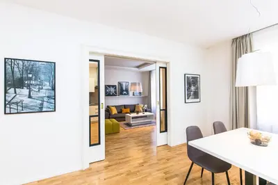 a white living room with a table and chairs at UNIQUE Old Town apartments at Palace Dlouha in Prague