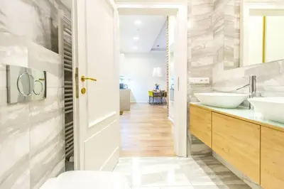a bathroom with two sinks and a mirror at UNIQUE Old Town apartments at Palace Dlouha in Prague
