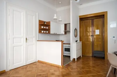 a kitchen with white cabinets and a white refrigerator at AIRSTAY PRAGUE apartment Vinohrady in Prague