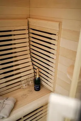 a sauna with two glasses and a bottle of wine at AIRSTAY PRAGUE apartment Vinohrady in Prague