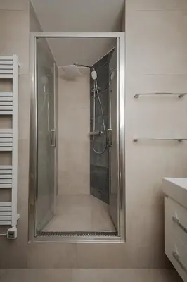 a shower with a glass door in a bathroom at AIRSTAY PRAGUE apartment Vinohrady in Prague