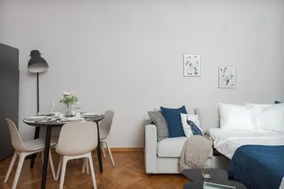 a living room with a bed and a table and a couch at AIRSTAY PRAGUE apartment Vinohrady in Prague