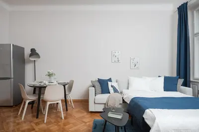 a bedroom with a bed and a table and a dining room at AIRSTAY PRAGUE apartment Vinohrady in Prague