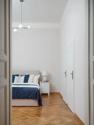 a bedroom with a bed and a white wall at AIRSTAY PRAGUE apartment Vinohrady in Prague