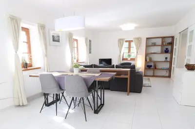 a kitchen and living room with a table and chairs at Chalupa Daisy Posázaví - rekreační ubytování blízko Prahy in Bohuliby