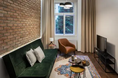 a living room with a table and chairs at Prague Days - Elegant Open-plan Apartment in Old Town in Prague